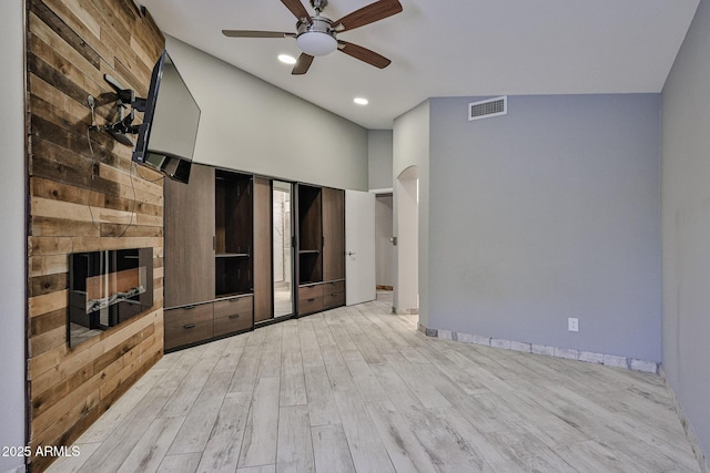17421 N 14th St, Phoenix, AZ 85022 - unfurnished living room with a ceiling fan, wood finished floors, baseboards, a fireplace, and arched walkways