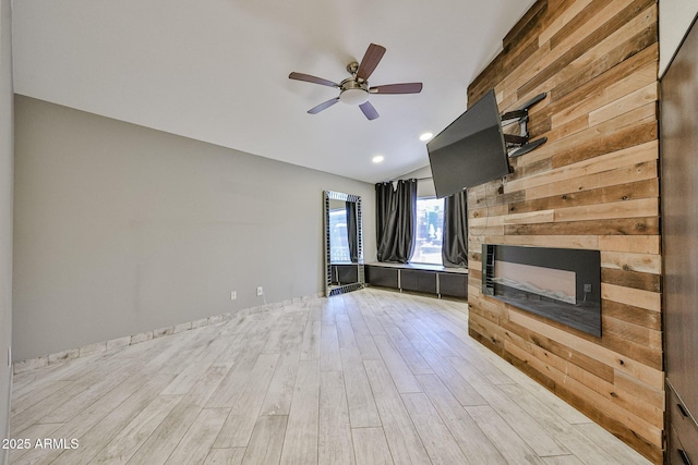 17421 N 14th St, Phoenix, AZ 85022 - unfurnished living room with lofted ceiling, a glass covered fireplace, ceiling fan, light wood-type flooring, and wooden walls