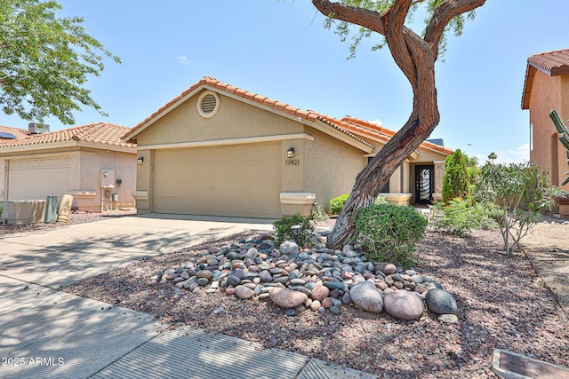 17421 N 14th St, Phoenix, AZ 85022 - mediterranean / spanish house featuring stucco siding, a garage, concrete driveway, and a tiled roof