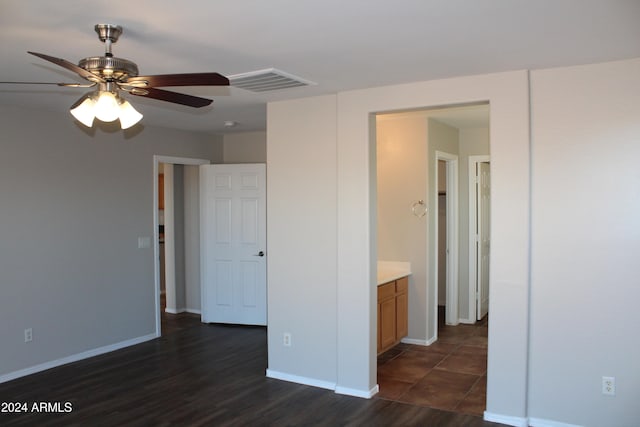 empty room with ceiling fan and dark wood-type flooring