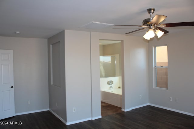 unfurnished bedroom with ceiling fan and dark wood-type flooring