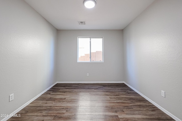 41208 W Bravo Dr, Maricopa, AZ 85138 - spare room with dark wood-style flooring and baseboards