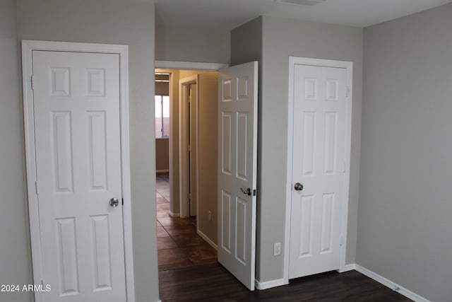 corridor with dark hardwood / wood-style flooring