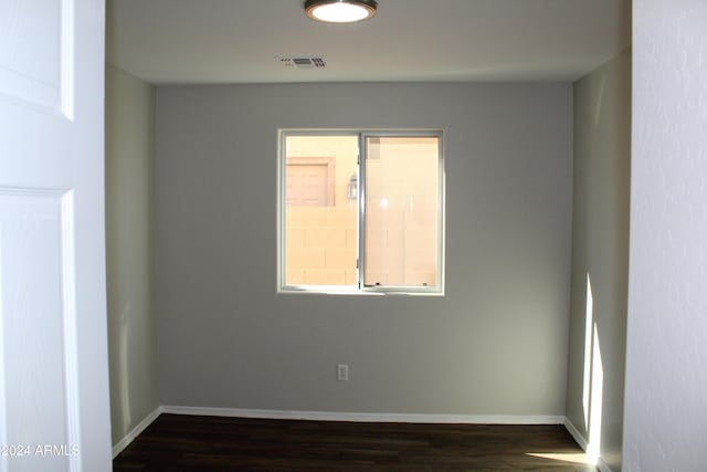 spare room featuring dark hardwood / wood-style flooring