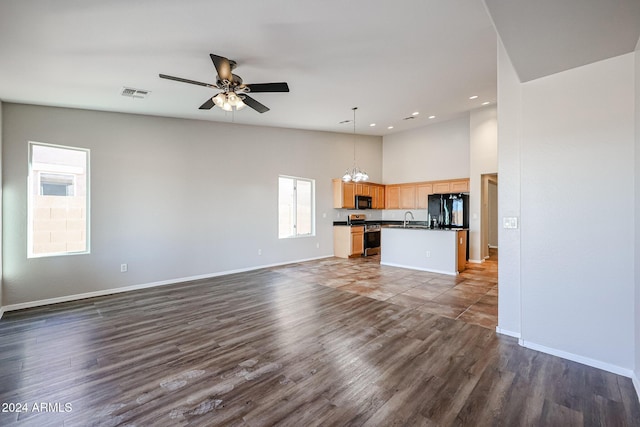 41208 W Bravo Dr, Maricopa, AZ 85138 - unfurnished living room featuring a high ceiling, a sink, ceiling fan, baseboards, and recessed lighting
