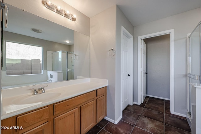 41208 W Bravo Dr, Maricopa, AZ 85138 - full bathroom with a stall shower, vanity, baseboards, and tile patterned floors