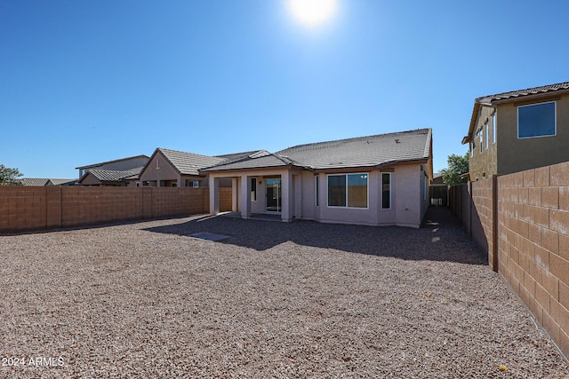 41208 W Bravo Dr, Maricopa, AZ 85138 - rear view of house with a fenced backyard, a tile roof, and stucco siding