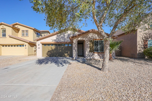 41208 W Bravo Dr, Maricopa, AZ 85138 - mediterranean / spanish home featuring stucco siding, driveway, an attached garage, and a tiled roof