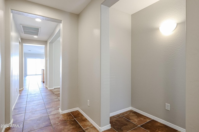 41208 W Bravo Dr, Maricopa, AZ 85138 - hallway with dark tile patterned flooring and baseboards