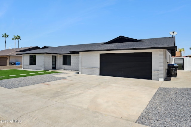 single story home with brick siding, a garage, driveway, and a shingled roof