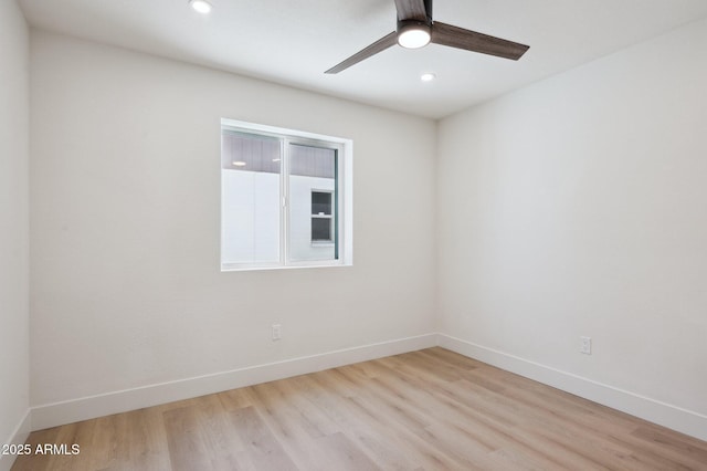 empty room featuring light wood finished floors, a ceiling fan, baseboards, and recessed lighting