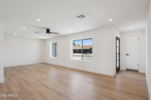 spare room featuring recessed lighting, light wood finished floors, a ceiling fan, and baseboards