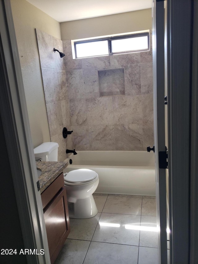 full bathroom with vanity, tiled shower / bath combo, toilet, and a wealth of natural light