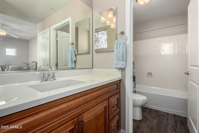 full bath with toilet, shower / bath combo, ceiling fan, vanity, and wood finished floors