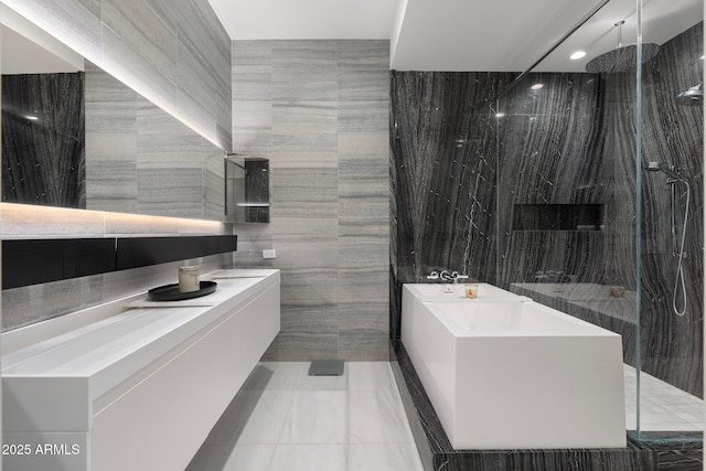 bathroom featuring a shower, vanity, and tile walls