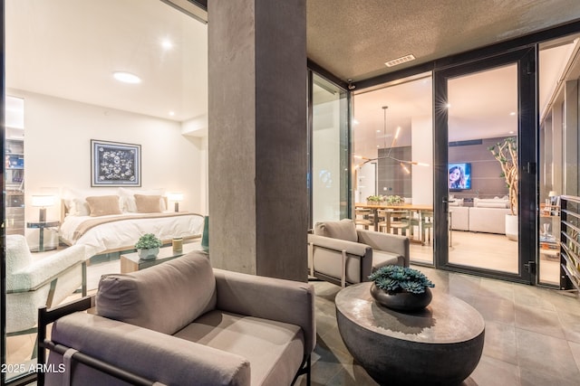 bedroom with floor to ceiling windows and a textured ceiling