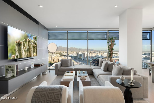 living room with light hardwood / wood-style flooring and floor to ceiling windows