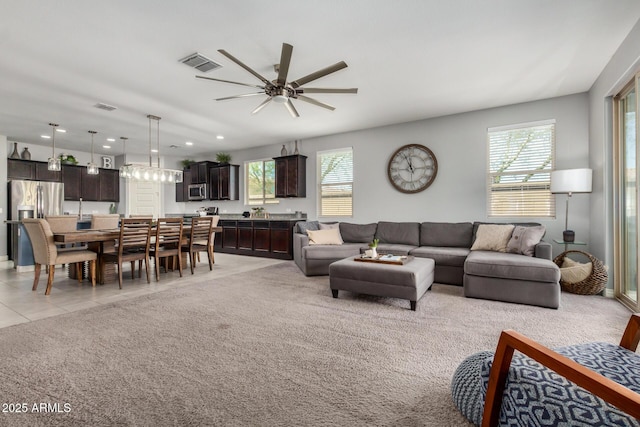 10454 W Maya Way, Peoria, AZ 85383 - living area featuring light tile patterned floors, light carpet, ceiling fan, and visible vents