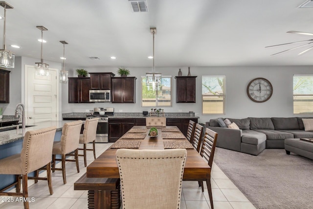 10454 W Maya Way, Peoria, AZ 85383 - dining area featuring light tile patterned flooring, visible vents, and a healthy amount of sunlight