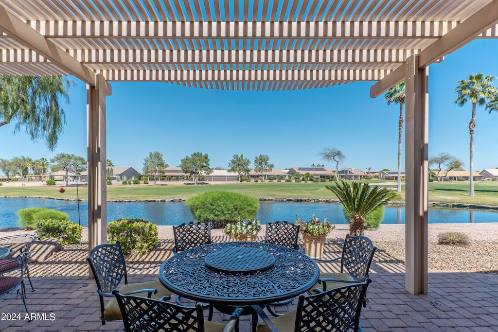 view of patio featuring a water view and a pergola