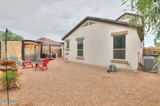 18309 N Crestview Ln, Maricopa, AZ 85138 - rear view of property featuring central AC unit, a pergola, stucco siding, and a patio area