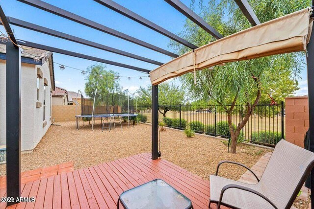 18309 N Crestview Ln, Maricopa, AZ 85138 - deck with a trampoline, a pergola, and a fenced backyard