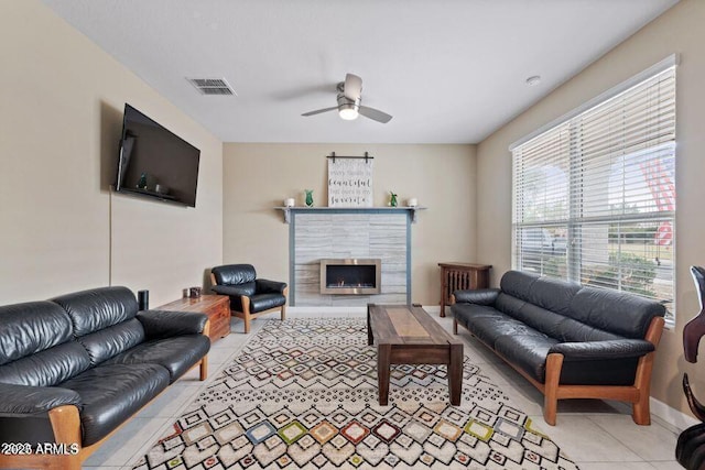18309 N Crestview Ln, Maricopa, AZ 85138 - living area featuring light tile patterned floors, ceiling fan, and a tiled fireplace