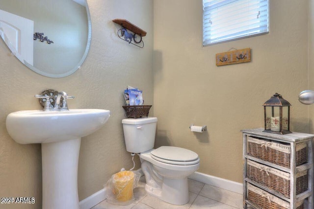 18309 N Crestview Ln, Maricopa, AZ 85138 - half bath featuring toilet, tile patterned flooring, a sink, and baseboards