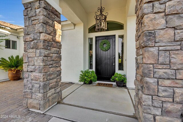 hall featuring light tile patterned floors and a tray ceiling