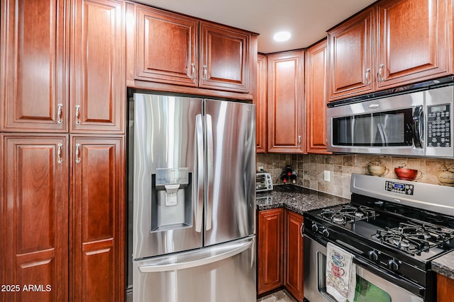 5350 E Deer Valley Dr Unit 2246, Phoenix, AZ 85054 - kitchen with tasteful backsplash, appliances with stainless steel finishes, brown cabinets, and dark stone countertops