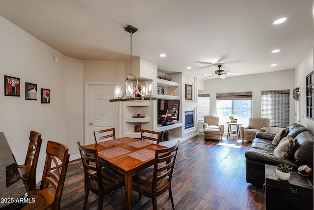 5350 E Deer Valley Dr Unit 2246, Phoenix, AZ 85054 - dining area featuring recessed lighting, ceiling fan with notable chandelier, baseboards, dark wood-style floors, and a glass covered fireplace