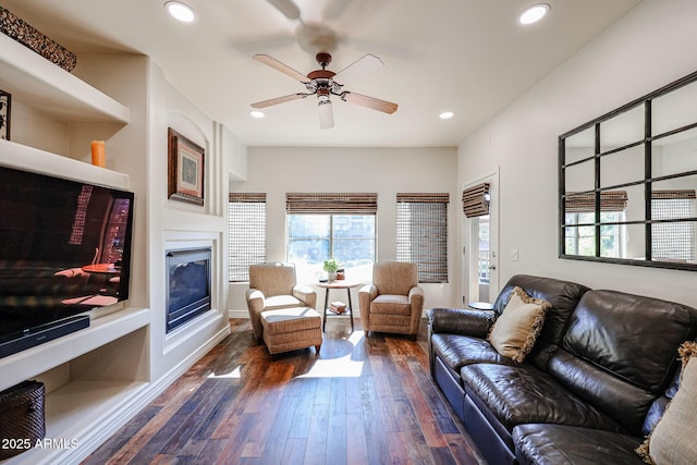 5350 E Deer Valley Dr Unit 2246, Phoenix, AZ 85054 - living room featuring ceiling fan, a glass covered fireplace, dark wood finished floors, and recessed lighting
