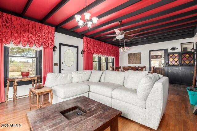 315 N 4th St, Tombstone, AZ 85638 - living room with beam ceiling, wood finished floors, ceiling fan with notable chandelier, and plenty of natural light