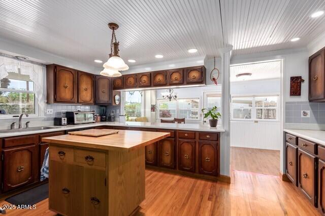 315 N 4th St, Tombstone, AZ 85638 - kitchen featuring plenty of natural light, wood counters, light wood-type flooring, a sink, and a center island