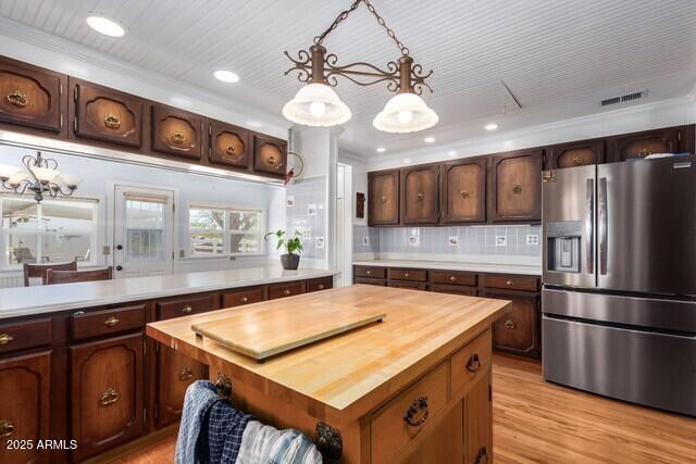 315 N 4th St, Tombstone, AZ 85638 - kitchen with tasteful backsplash, wood counters, stainless steel fridge with ice dispenser, light wood finished floors, and pendant lighting