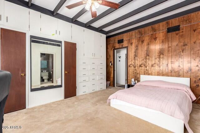 315 N 4th St, Tombstone, AZ 85638 - bedroom featuring beam ceiling, light colored carpet, wooden walls, and ceiling fan