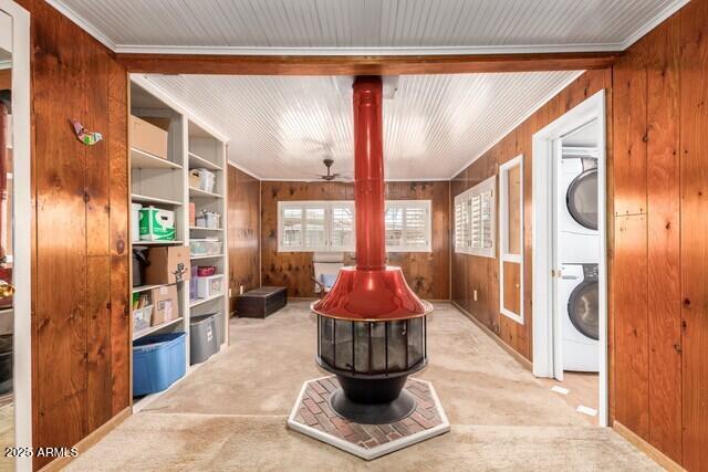 315 N 4th St, Tombstone, AZ 85638 - interior space featuring stacked washer / dryer, a fire pit, and wood walls
