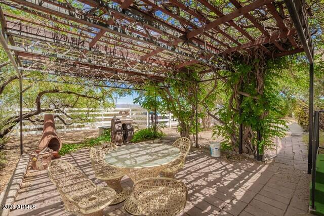 315 N 4th St, Tombstone, AZ 85638 - view of patio / terrace with a pergola and outdoor dining space