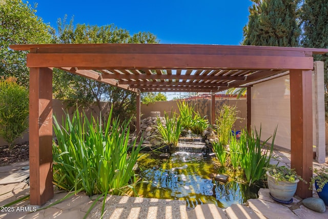 view of patio / terrace featuring fence and a pergola