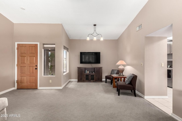 interior space with visible vents, a chandelier, baseboards, and light colored carpet