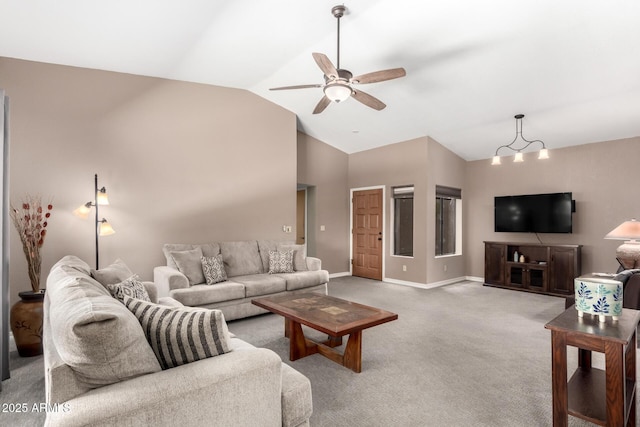 living room with high vaulted ceiling, light colored carpet, baseboards, and ceiling fan with notable chandelier