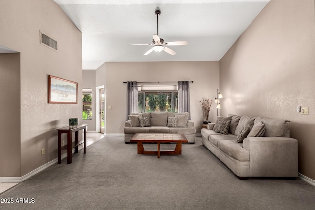 carpeted living area with a ceiling fan, visible vents, and baseboards