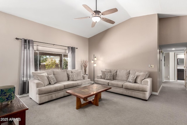 living area featuring carpet floors, high vaulted ceiling, a ceiling fan, and baseboards