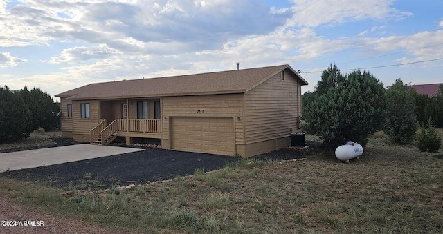 view of front facade featuring central AC unit and a garage