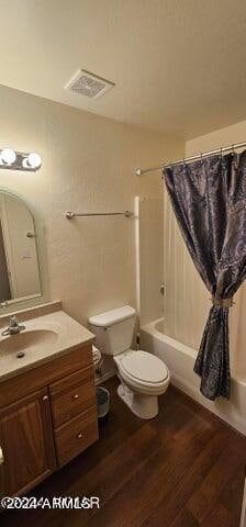 full bathroom featuring shower / bathtub combination with curtain, wood-type flooring, vanity, and toilet