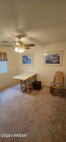 sitting room with ceiling fan and carpet floors