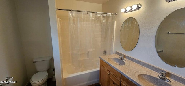 full bathroom with vanity, shower / tub combo, and toilet