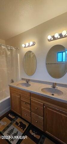 bathroom featuring shower / bath combination with curtain and vanity