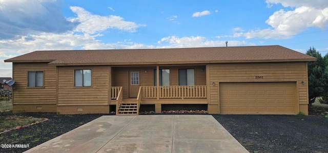 ranch-style house featuring a garage and covered porch