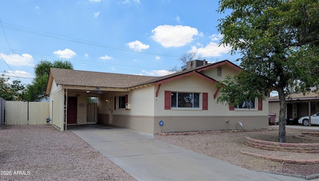 7250 E Mckellips Rd, Scottsdale, AZ 85257 - ranch-style home with concrete driveway, an attached carport, a shingled roof, and brick siding